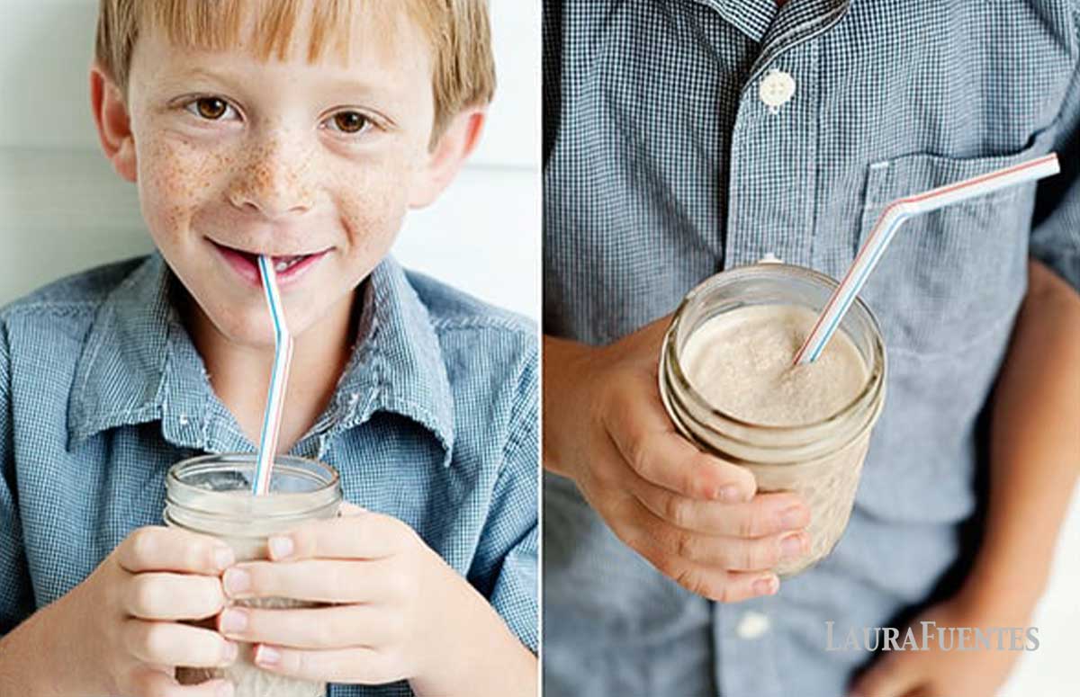 A side by side image of a kid sipping a chocolate smoothie through a straw and a close up of the chocolate smoothie in a jar with a straw. 