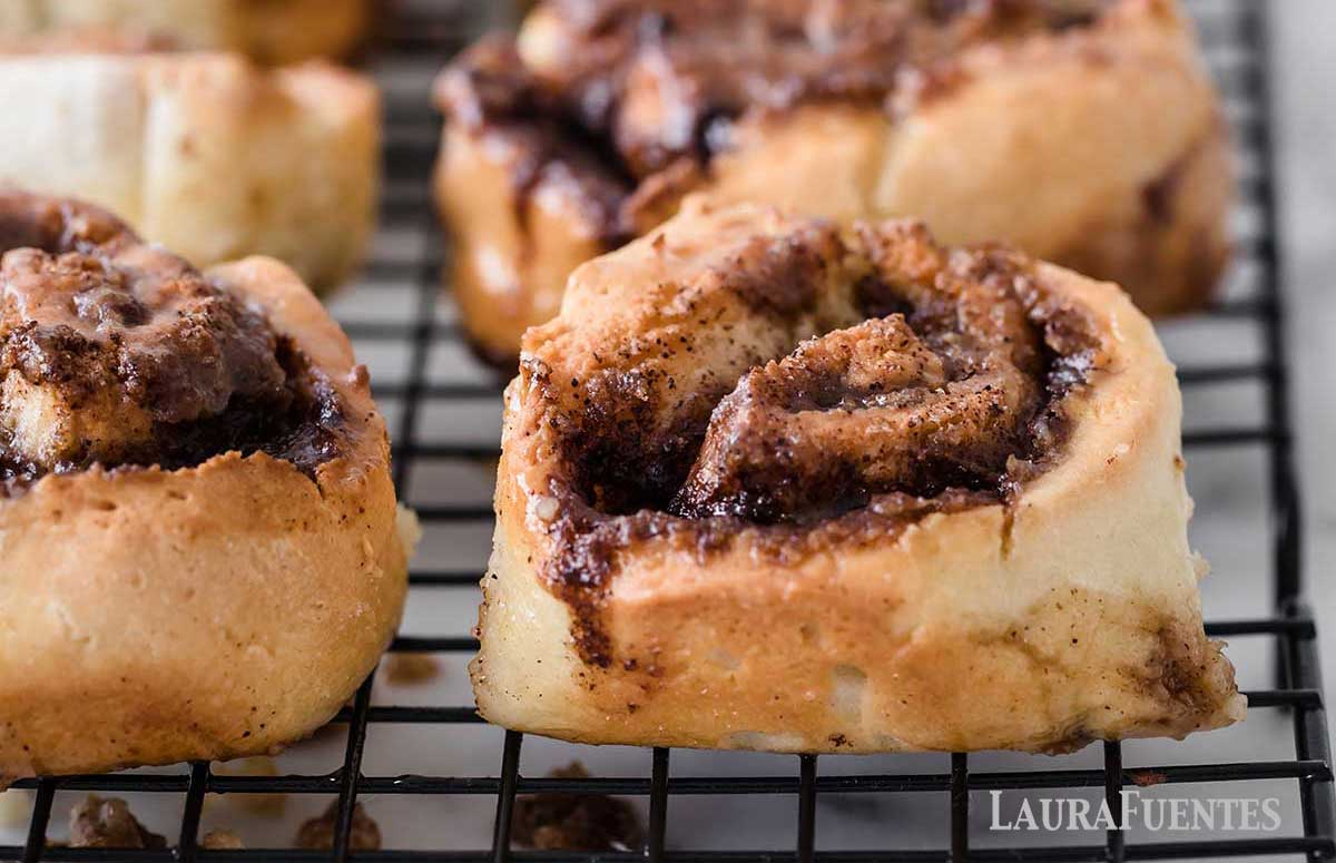 whole wheat cinnamon rolls in rows on a cooling rack