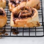 whole wheat cinnamon rolls in rows on a cooling rack