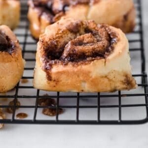 whole wheat cinnamon rolls in rows on a cooling rack