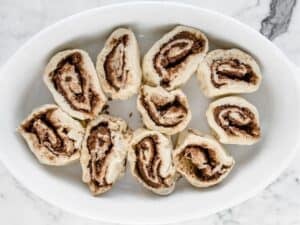 uncooked cinnamon rolls in a baking dish