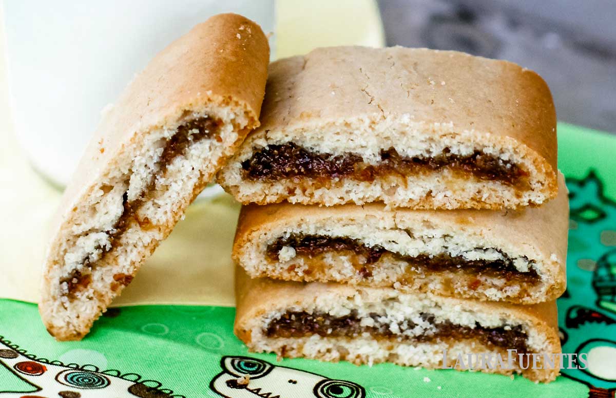 small stack of homemade raisin fig newtons with a glass of milk