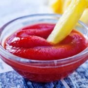 small glass dish of homemade ketchup with a french fry in it