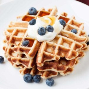 closeup on a stack of waffles with blueberries