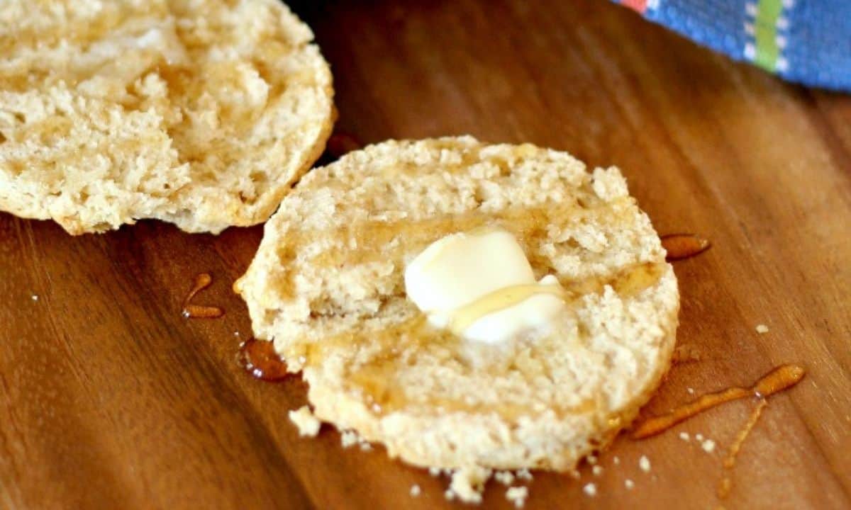 one whole wheat biscuits sliced in half with butter on top