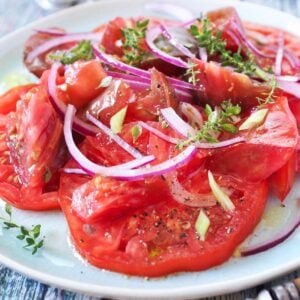 creole tomato salad with onion in a white dish