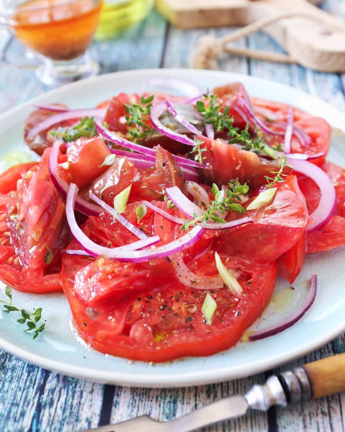 creole tomato salad with onion in a white dish