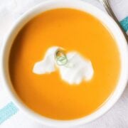 large bowl of orange colored spiced butternut squash soup