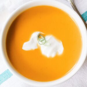 large bowl of orange colored spiced butternut squash soup