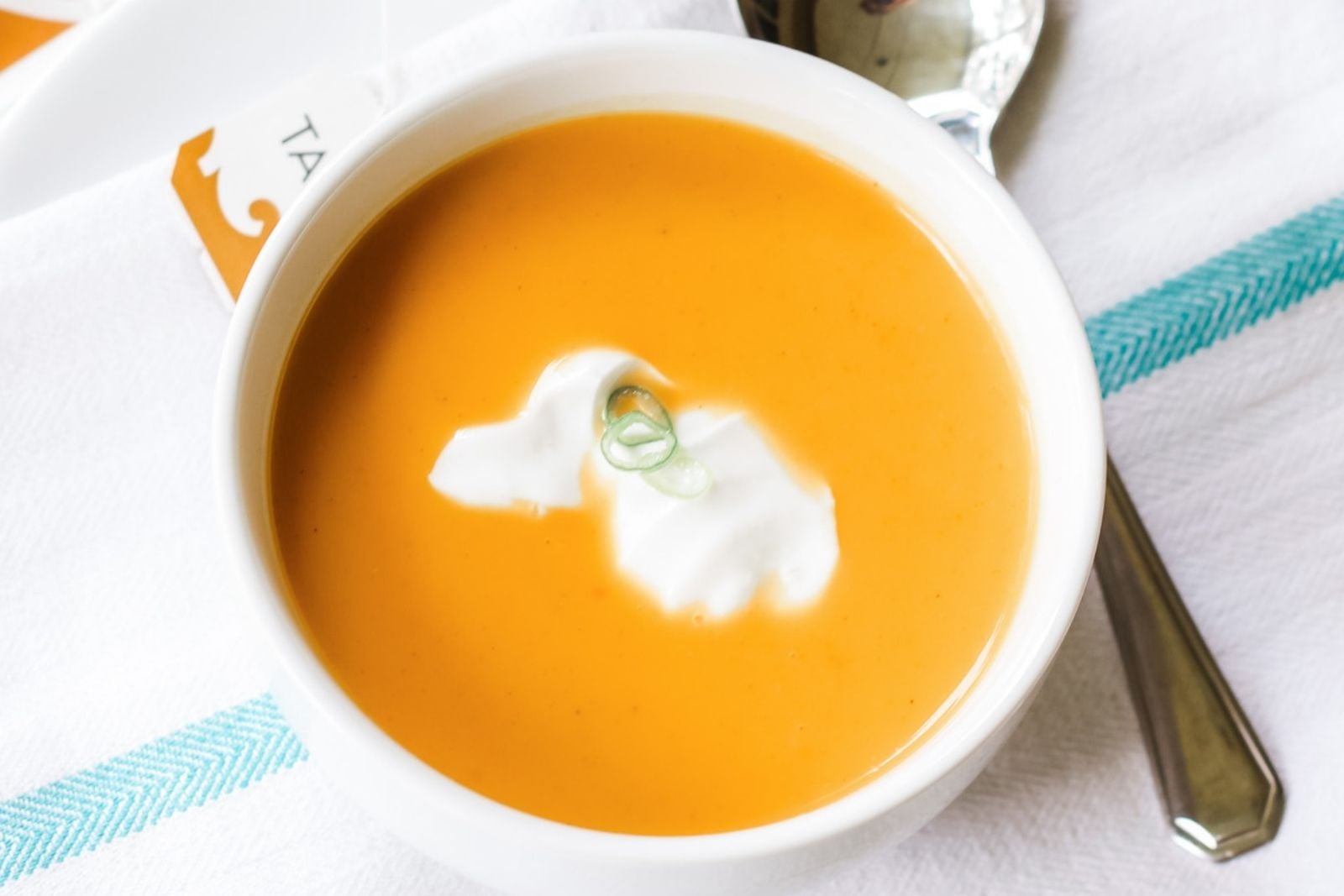 large bowl of orange colored spiced butternut squash soup