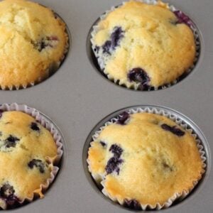 top view of four blueberry muffins in a muffin tin