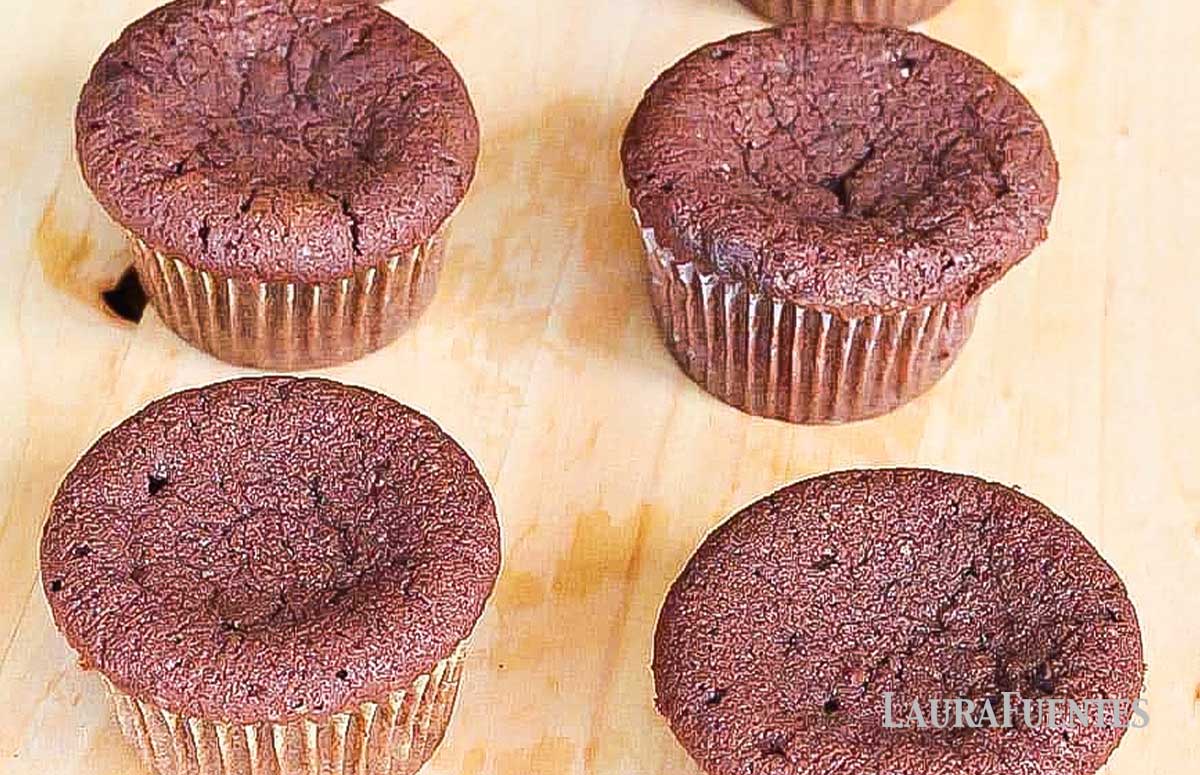 four cupcakes with concave tops