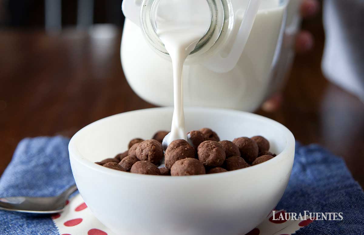cocoa puffs in a bowl milk pouring into it