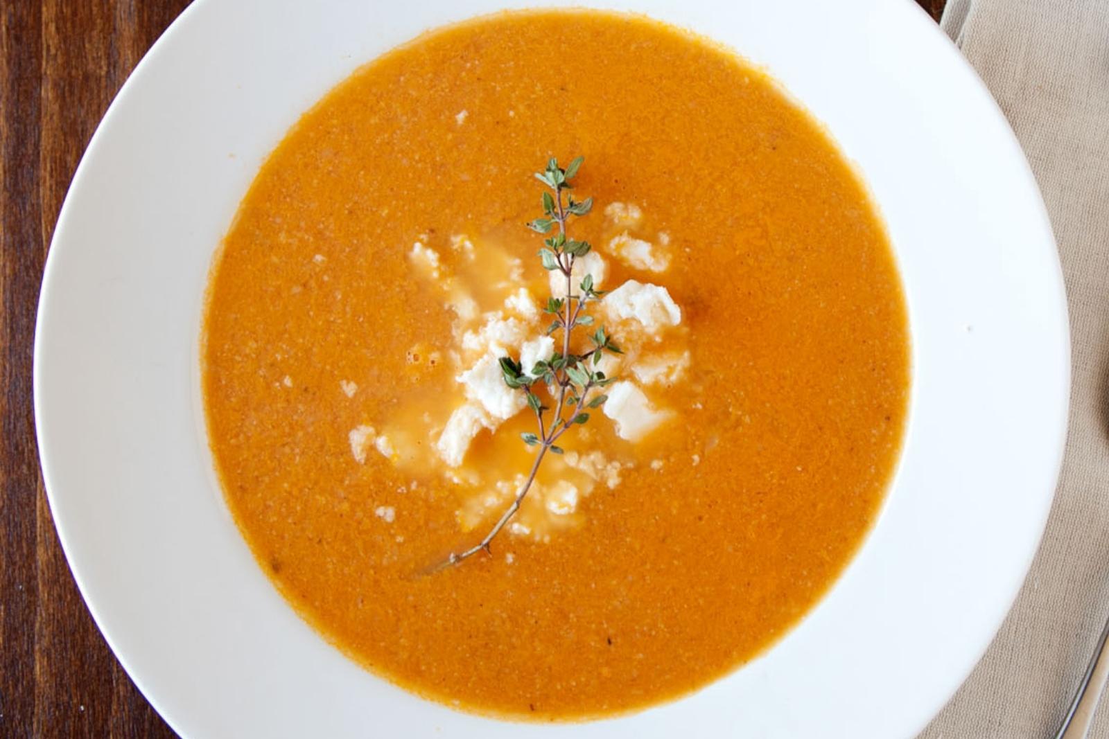 overhead view of roasted tomato soup in a white bowl
