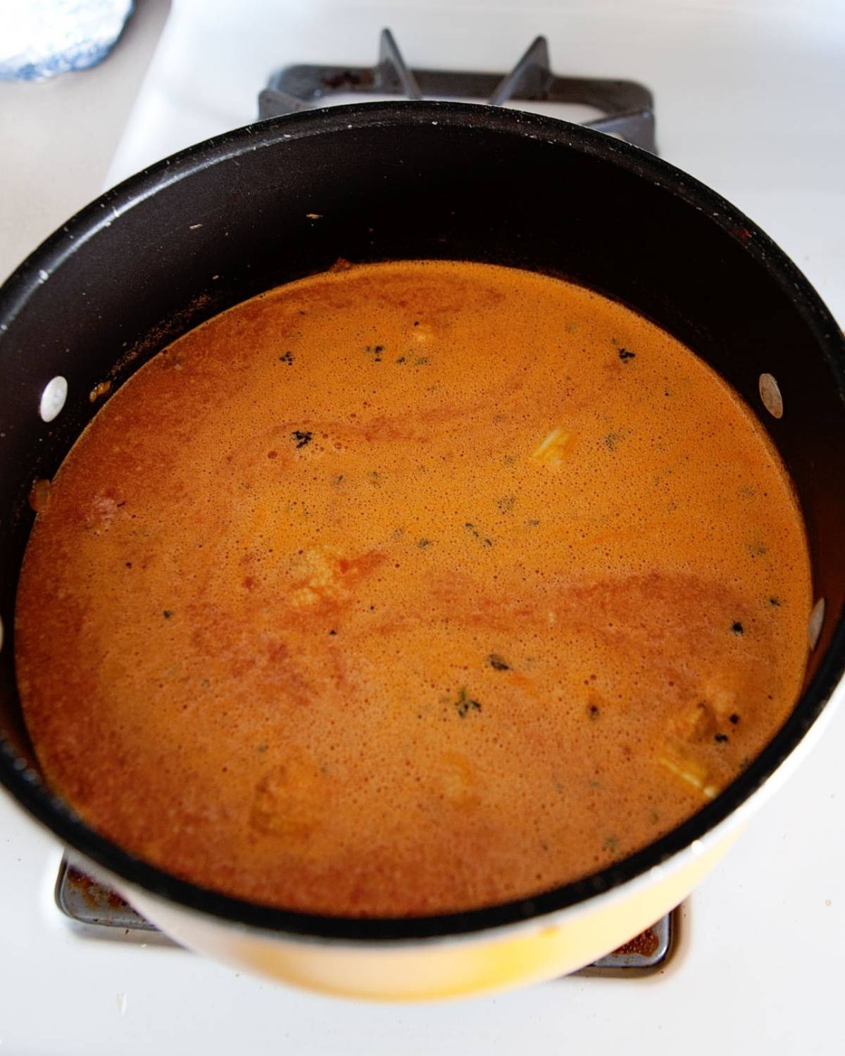 overhead view of roasted tomato soup in a pot