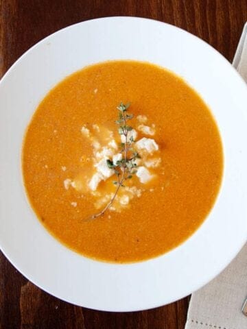 overhead view of roasted tomato soup in a white bowl