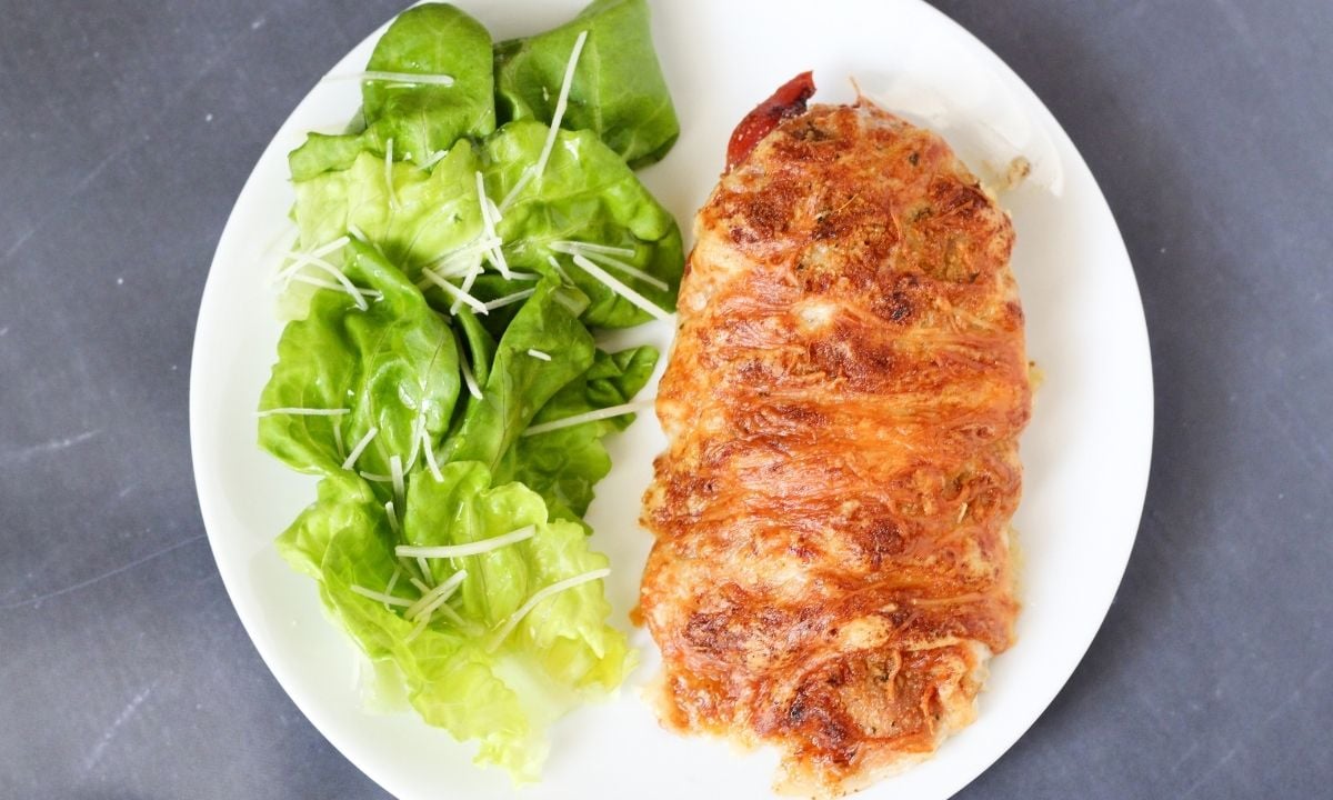 chicken cordon bleu with lettuce leaves on the side