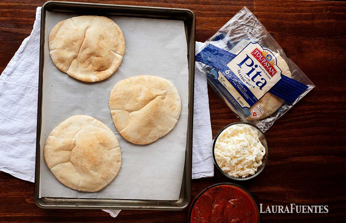ingredients of pita pizza: pitas, tomato sauce and cheese