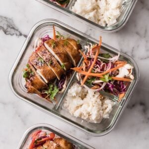 korean chicken with rice and slaw in a glass lunch container