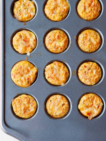 overhead view of zesty mini quiches in a tin muffin pan