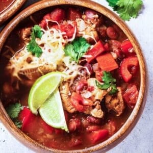 closeup of a bowl of turkey chili topped with sliced limes