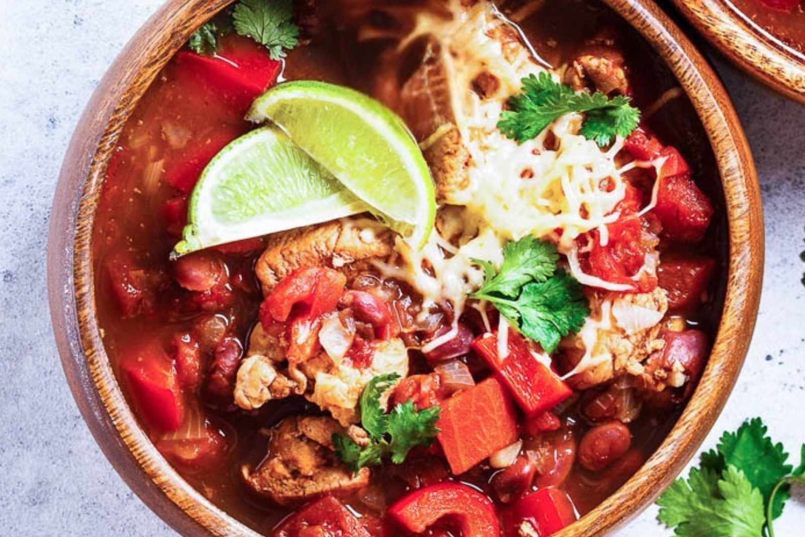 closeup of a bowl of turkey chili topped with sliced limes