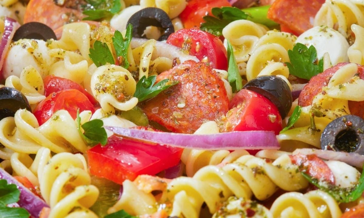 close up of pasta salad with pizza toppings