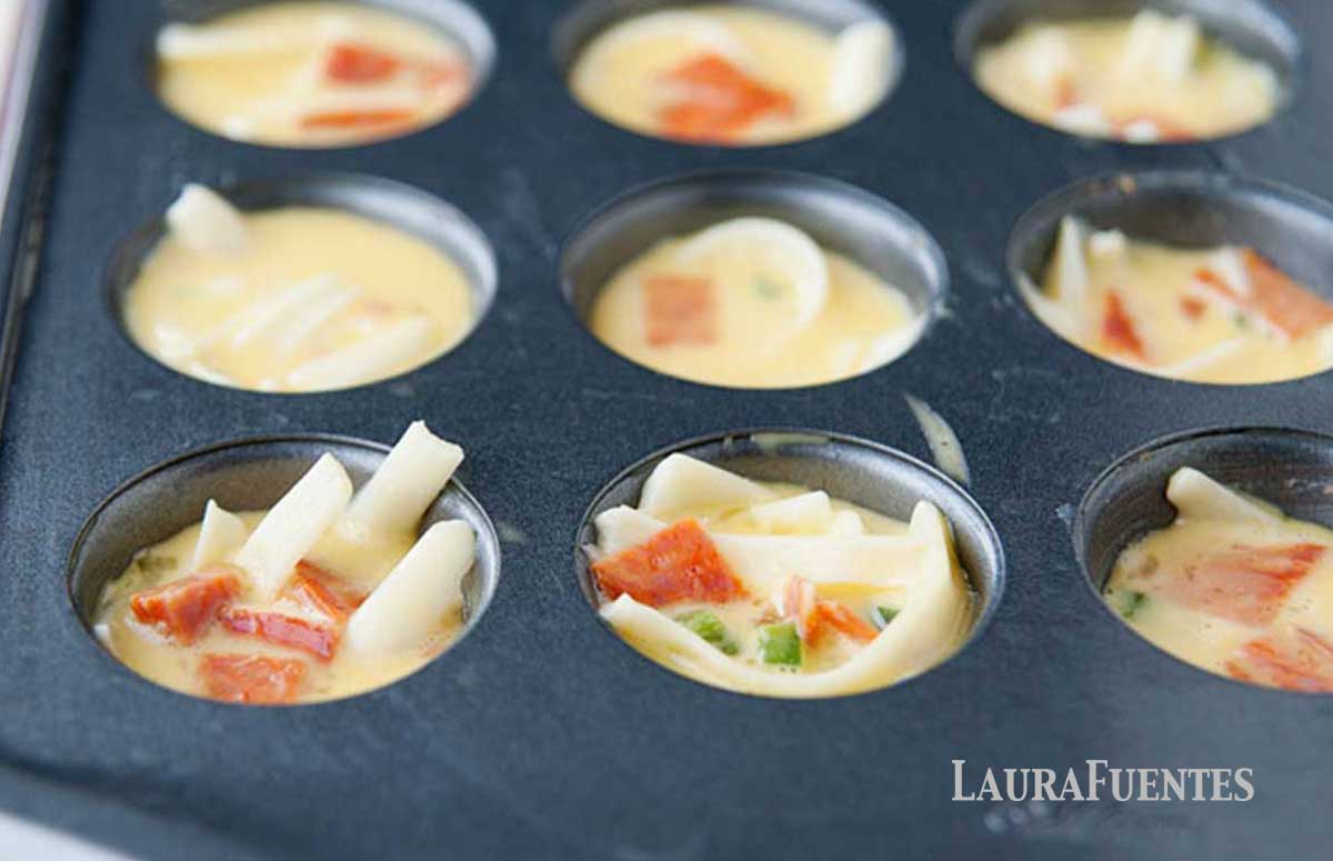 mini quiches in a mini muffin baking tray before baking