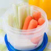 carrot sticks and celery sticks in a small cup of ranch dressing