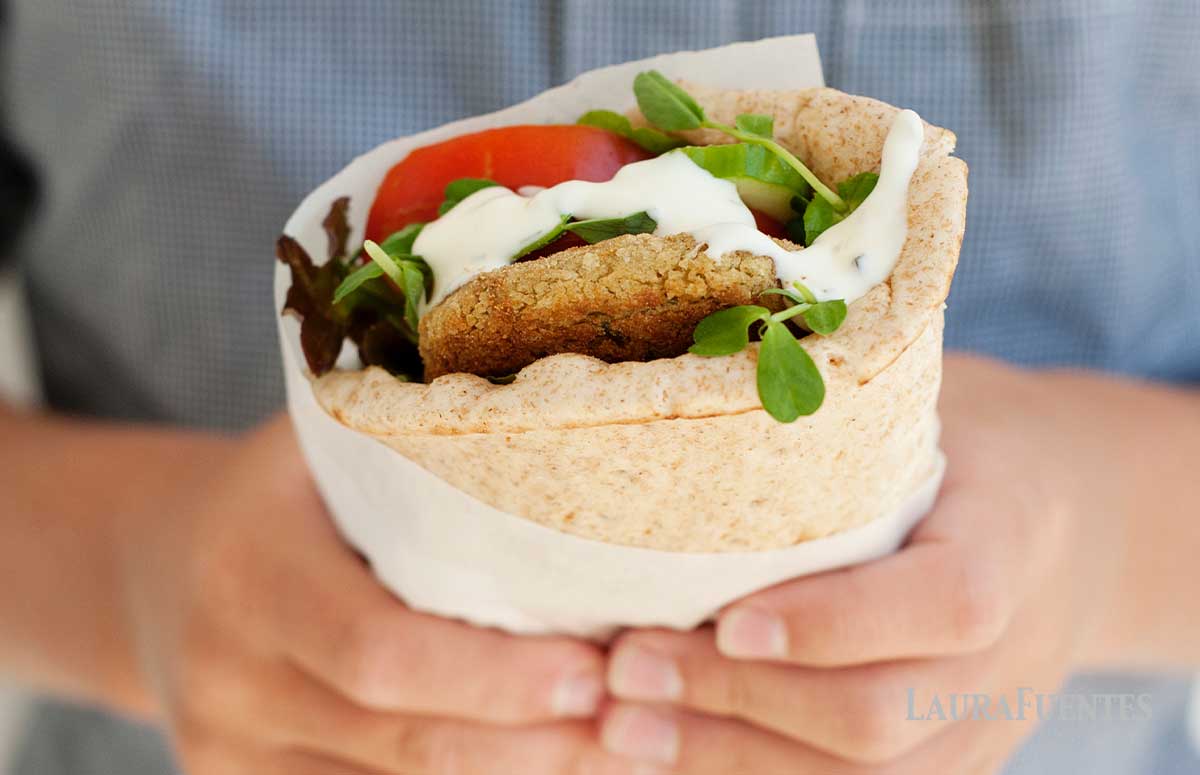falafel pita sandwich held in hand