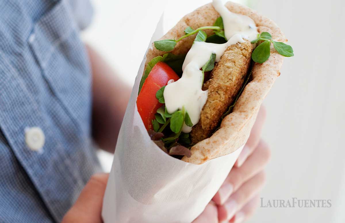 falafel pita sandwich held in hand