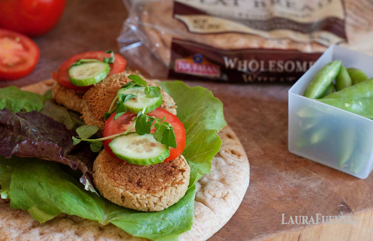 ingredients to build falafel stuffed flatbreads with assembly of falafels on the counter