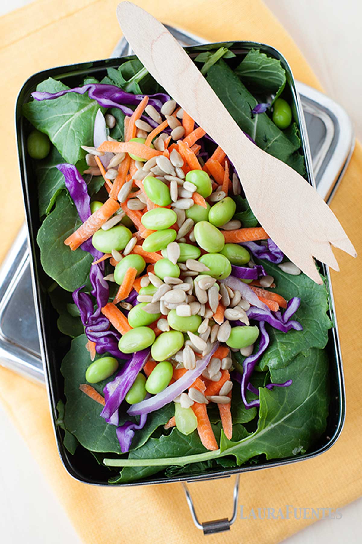 kale salad in a lunchbox with a fork