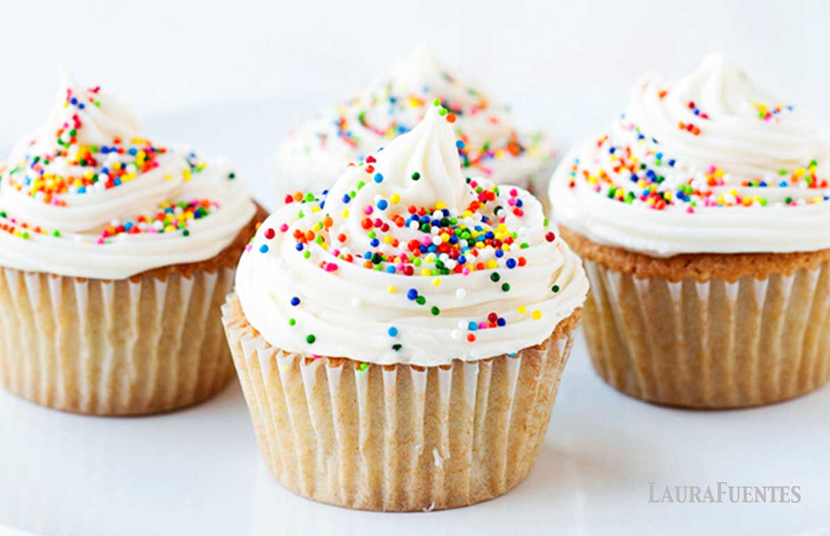 three birthday cupcakes on a white plate