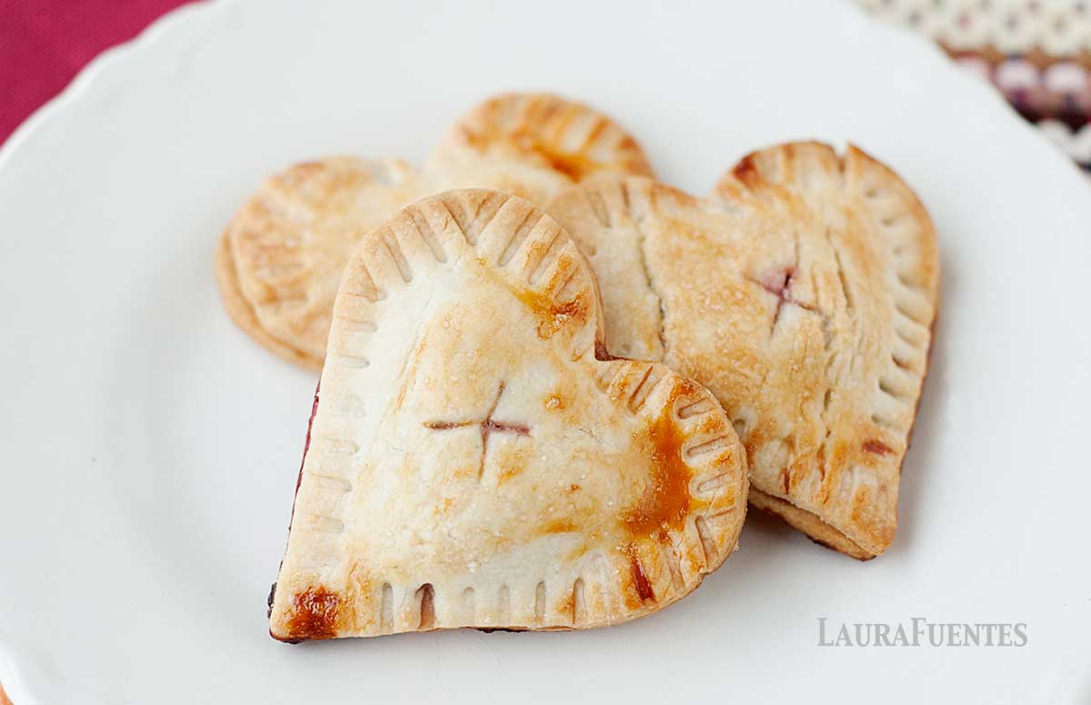 three cherry hand pies on a white plate