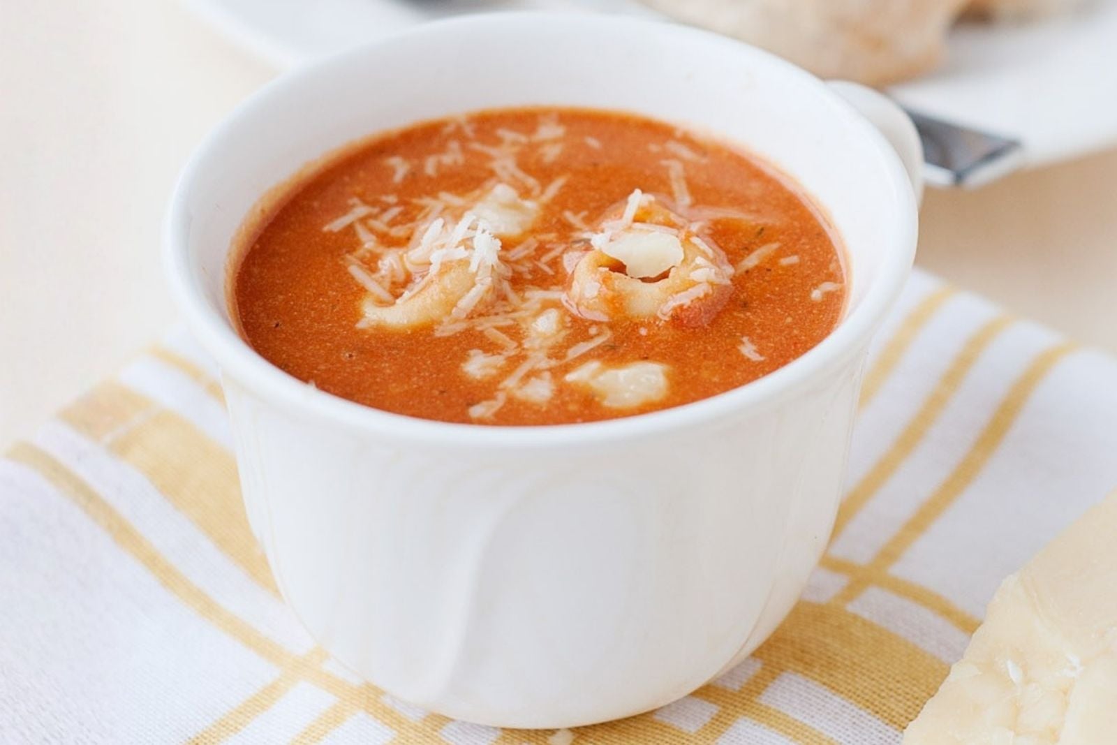 a cup of tomato tortellini soup