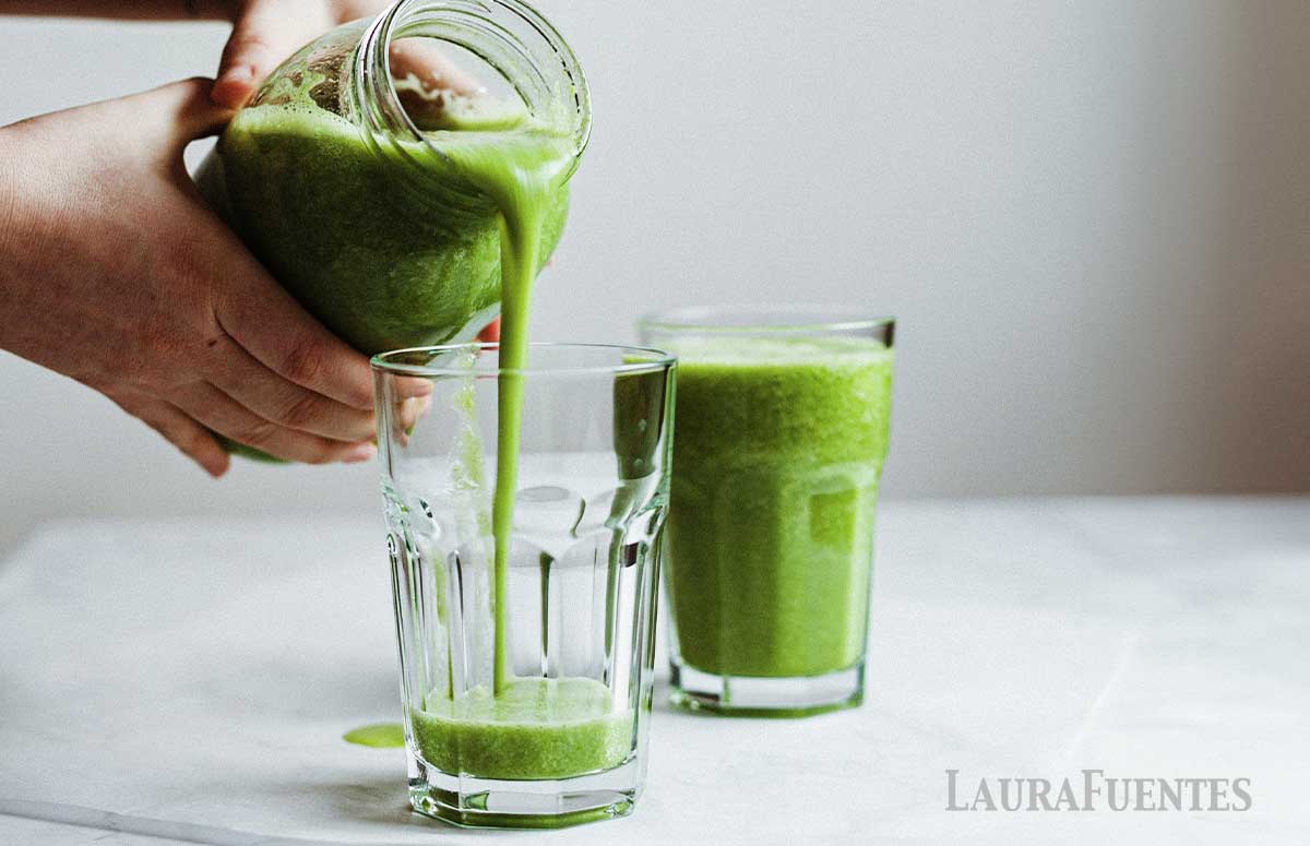 someone pouring green smoothies in glasses for st patricks day