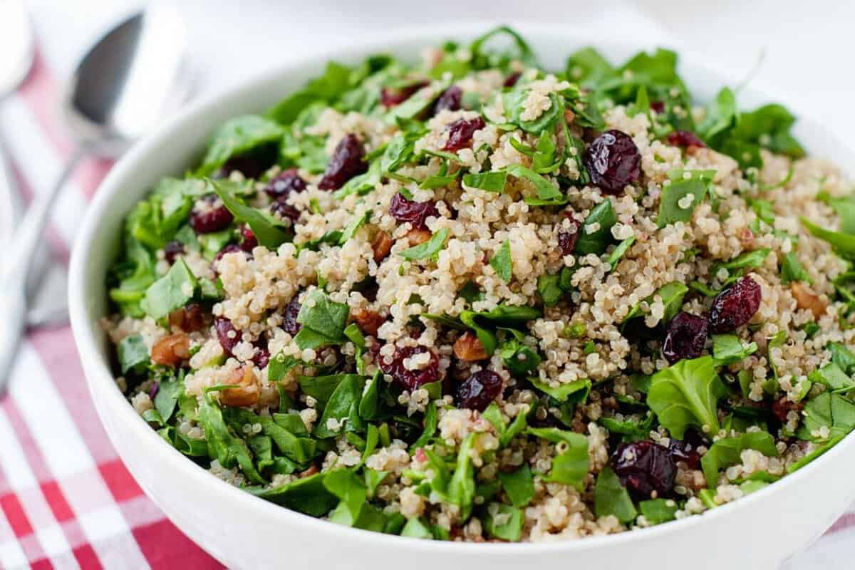 a bowl quinoa salad with cranberries and greens