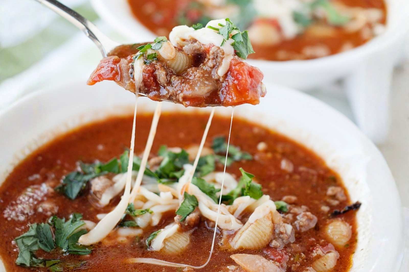 a bowl of lasagna soup and a spoonful of it