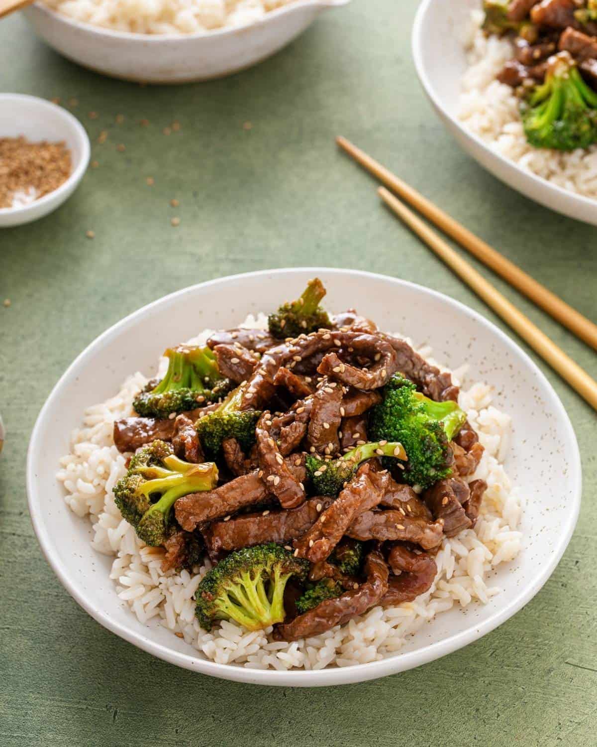front view of beef broccoli over rice on a plate.