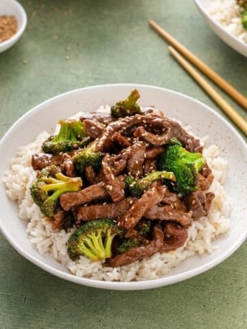 front view of beef broccoli over rice on a plate.