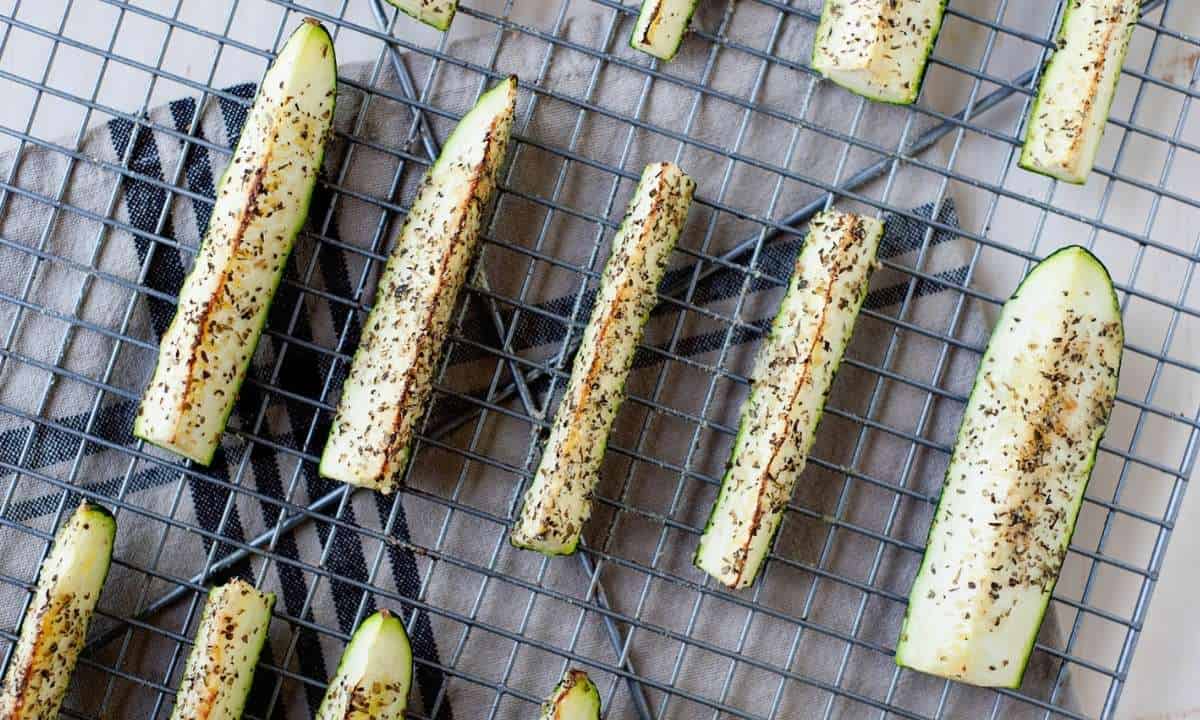 overhead view of roasted zucchini spears in a cooling rack