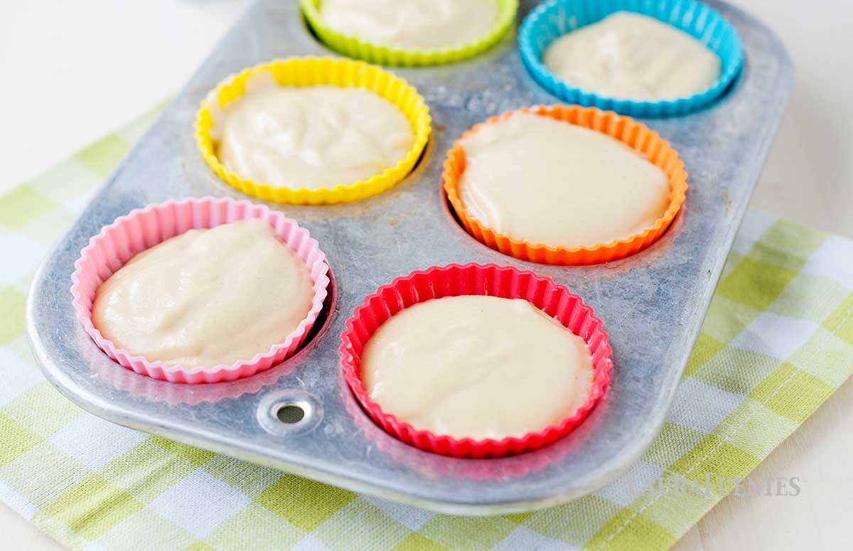 a muffin pan with muffin batter