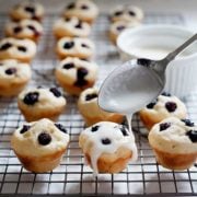 blueberry pancake muffins on a cooling rack with glaze