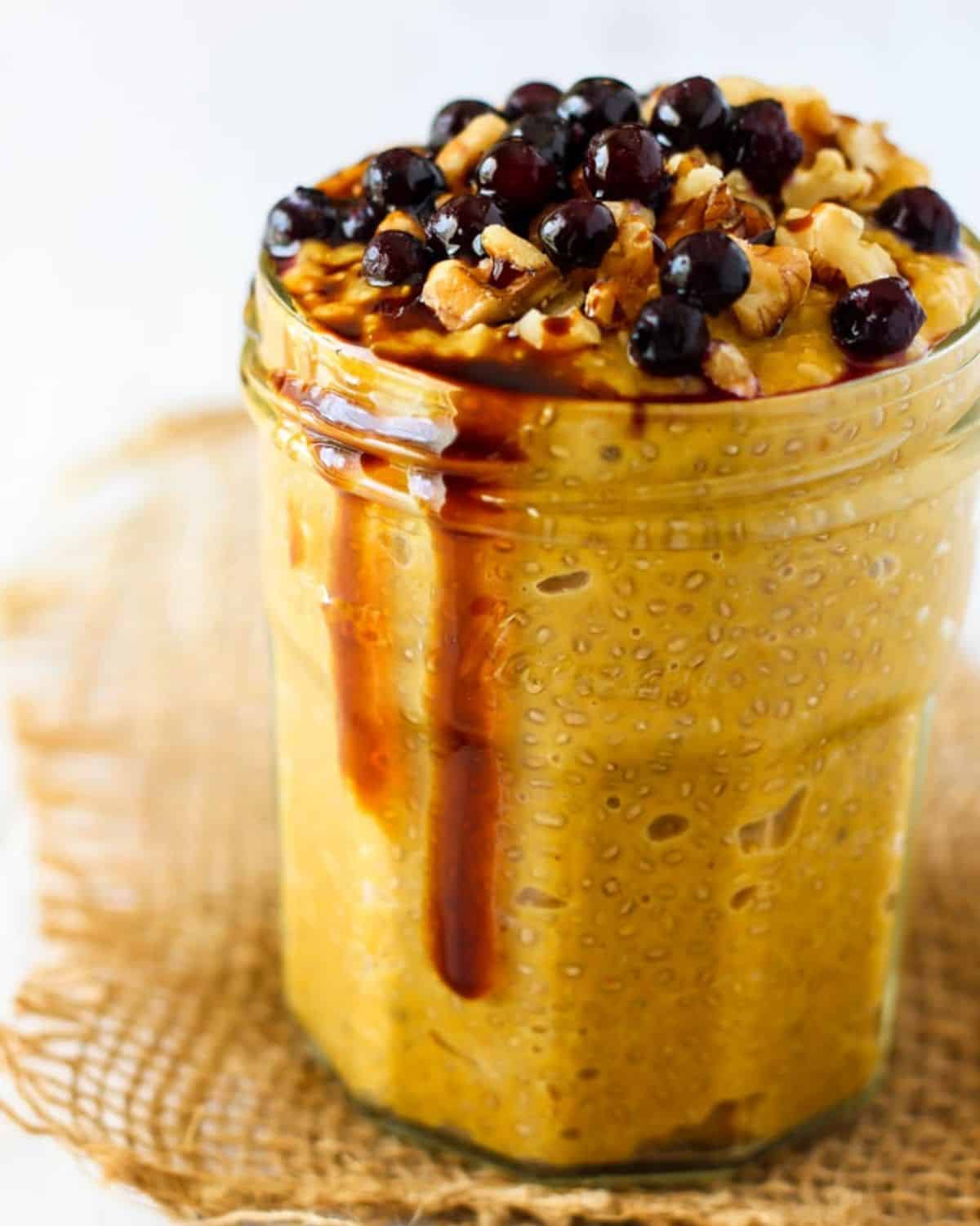 jar with pumpkin chia pudding topped with chocolate chips
