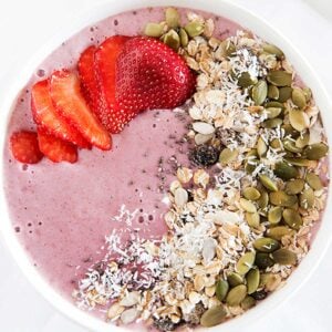 overhead view of strawberries and cream smoothie bowl