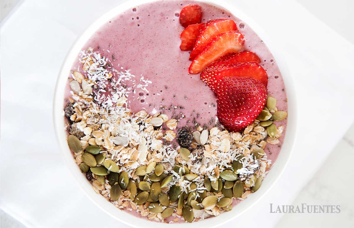 overhead view of strawberries and cream smoothie bowl