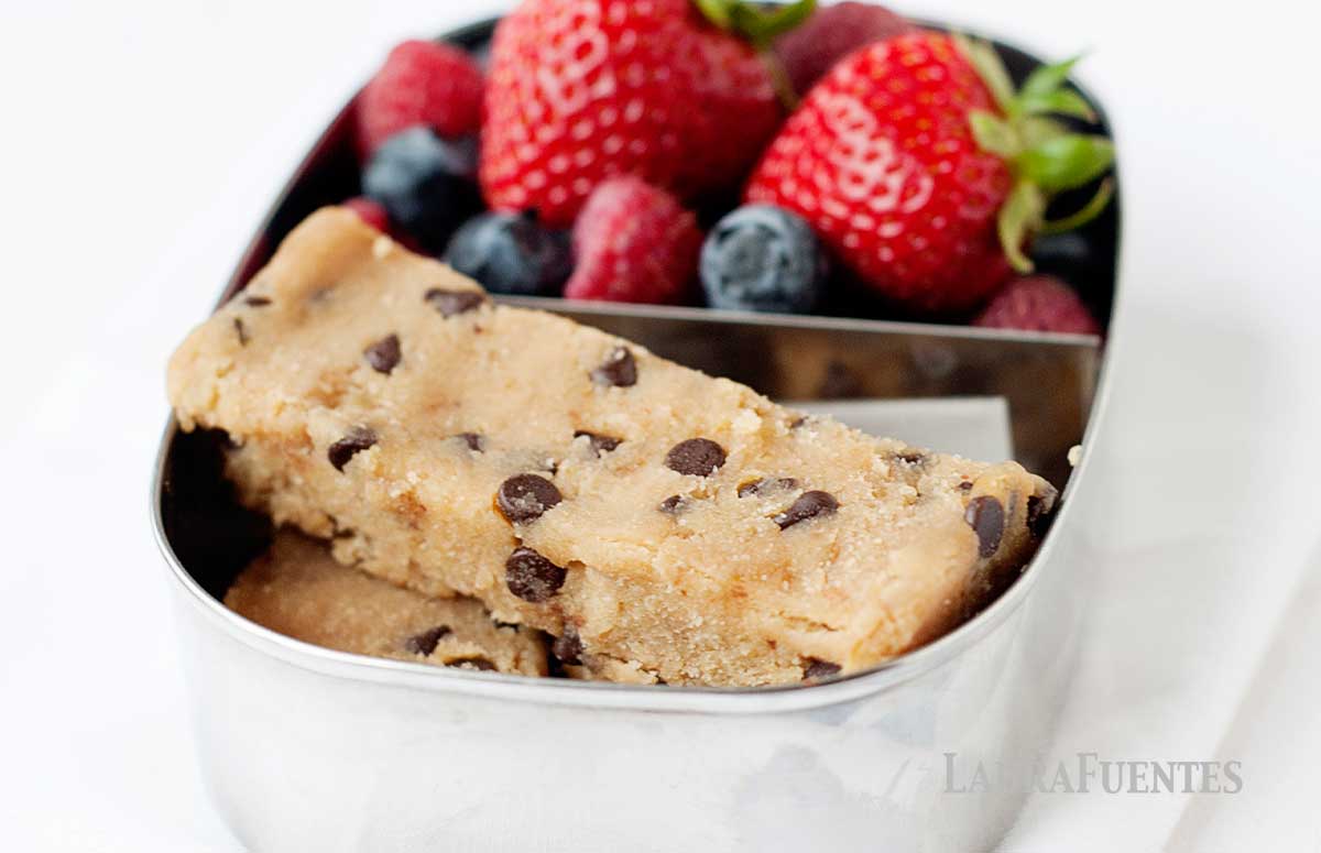 three no bake blondies in a small snack box with berries