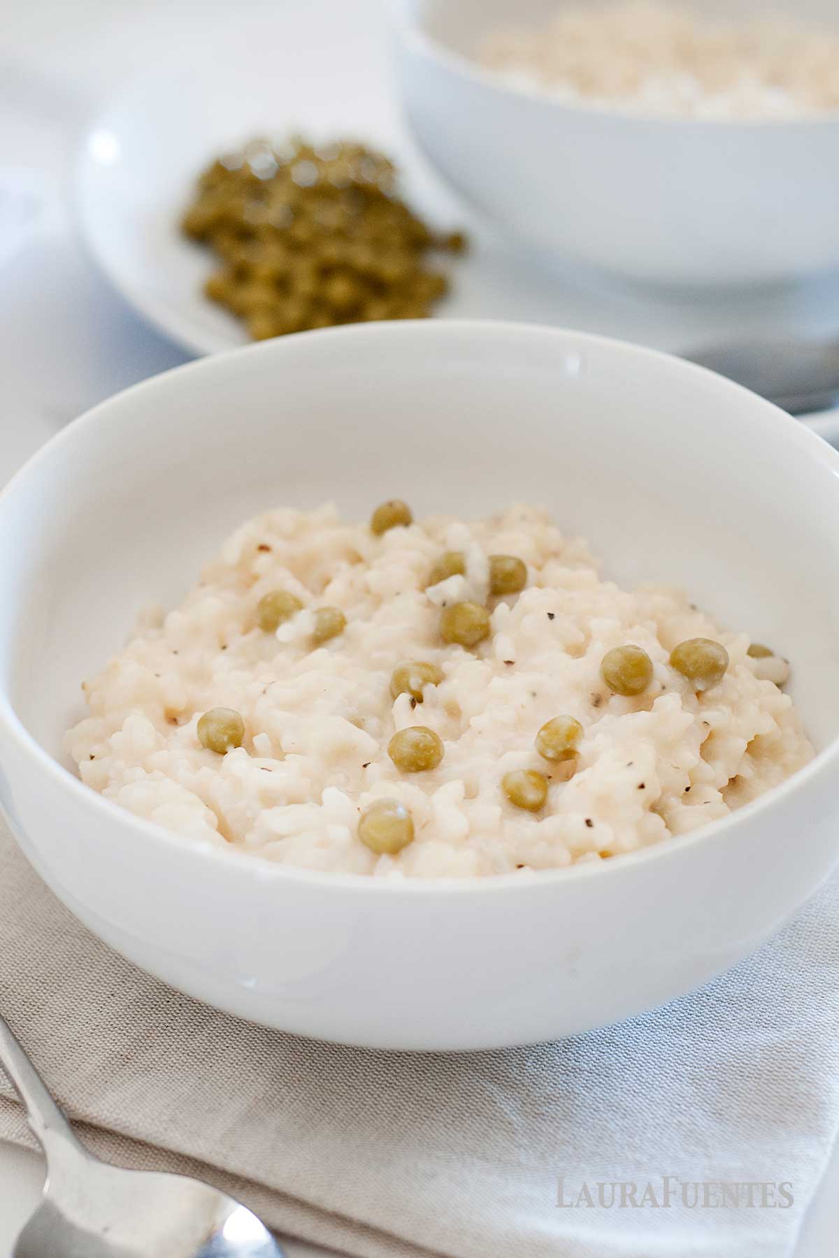 closeup of a big bowl of risotto with parmesan and peas