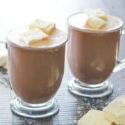 two mugs of protein powder hot chocolate topped with marshmallows